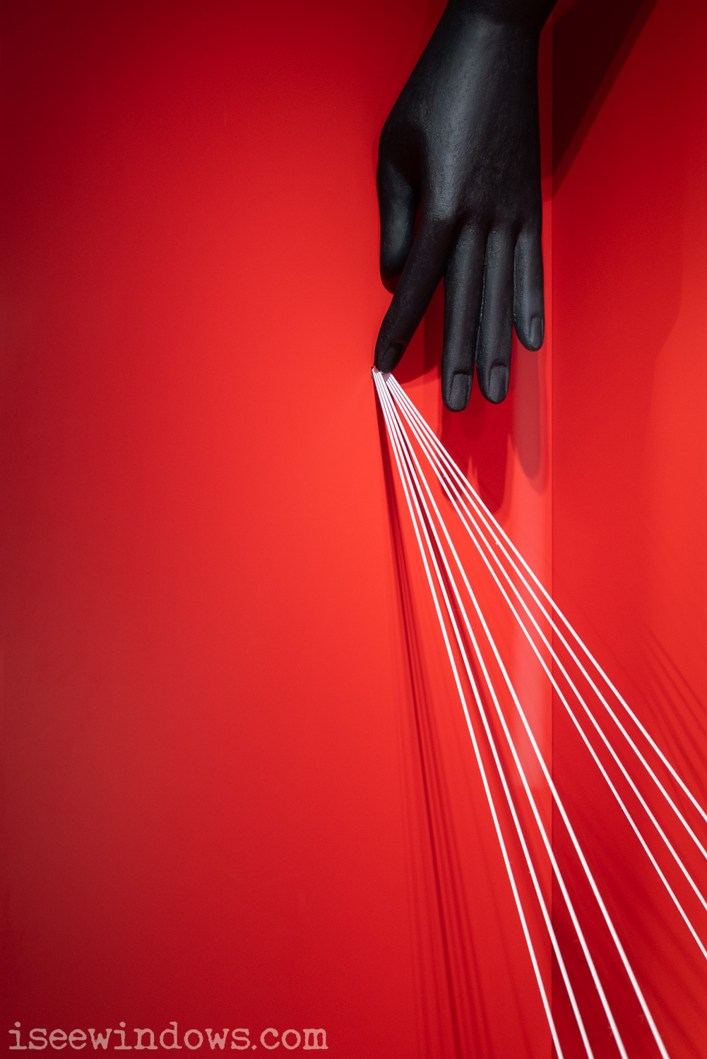 2023/04 FERRAGAMO - Milan Design Week close-up of a hand holding some strings retail photo